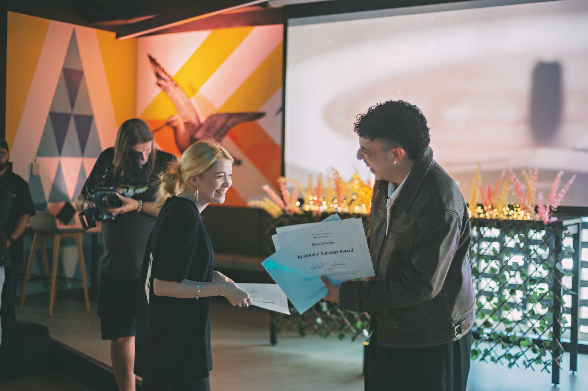 Juno presents a student from the Digital Creativity Foundation programme a Top Achiever award