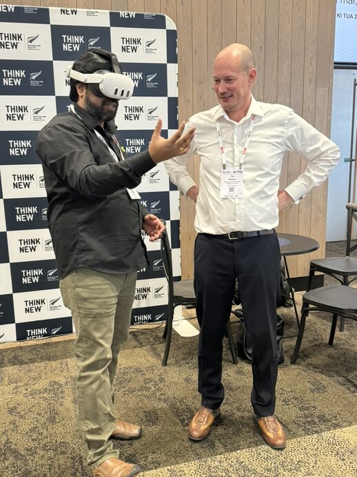 Conference delegate experiencing Nani Parlapalli’s VR experience, watched on by Education New Zealand’s Tim Brown