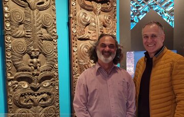 Te Hira Henderson and Dr Moana Nepia, Senior Research Fellow Media Design School in front of two of the carved wooden pou at Heretaunga III.